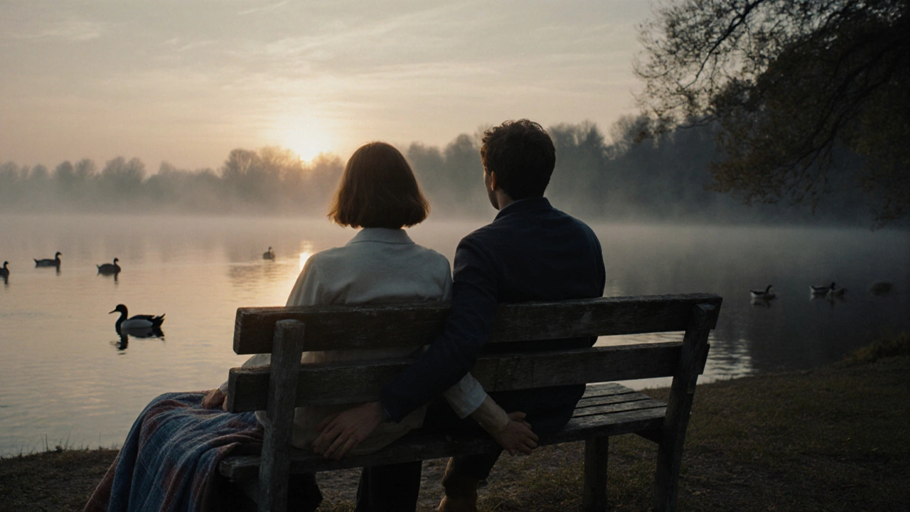 Two people sitting hand in hand on a lakeside bench at sunset, watching ducks in peaceful silence.
