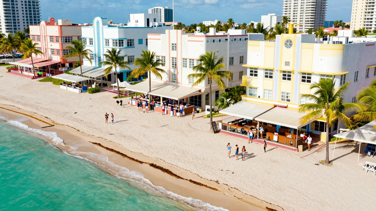 Aerial view of Miami Beach with people socializing near colorful Art Deco buildings and turquoise water.