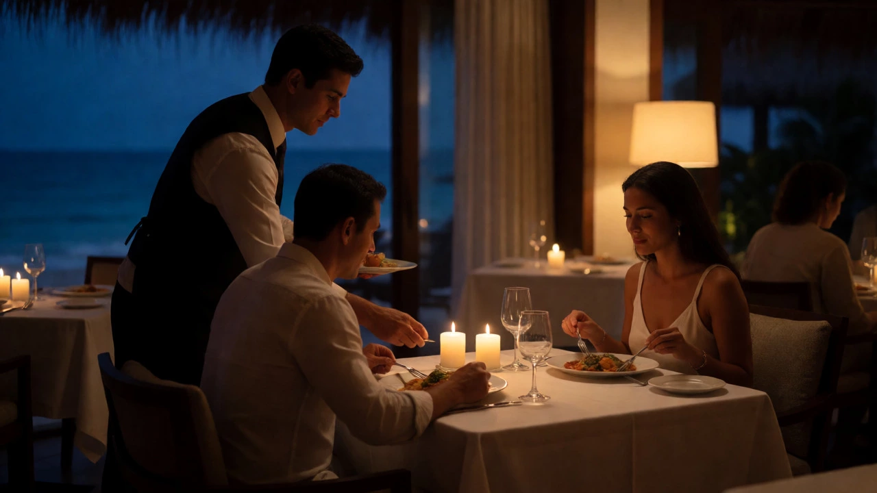 Waiter receiving a tip at a candlelit beachfront restaurant table